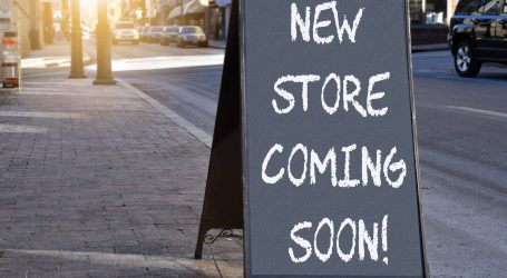 chalkboard-sign-on-sidewalk-proclaiming-new-store-2023-11-27-05-16-18-utc